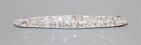 An early 20th century 15ct & Pt, diamond set twin row bar brooch, 57mm.